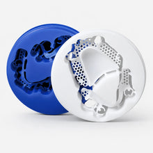 Blue and white dental wax discs with milled removable framework patterns