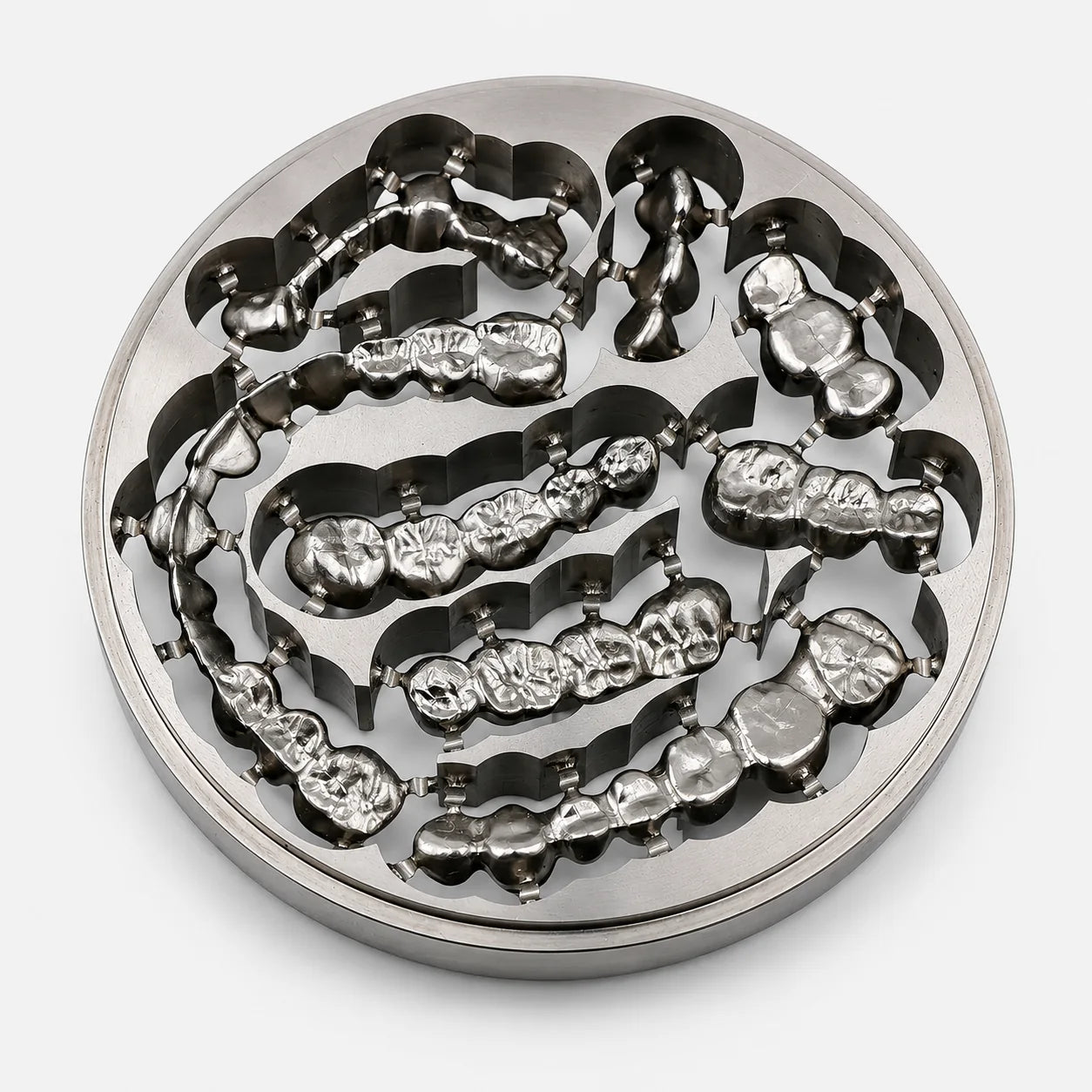 Grade 2 titanium disc with milled dental crowns and bridge restorations for CAD/CAM workflows