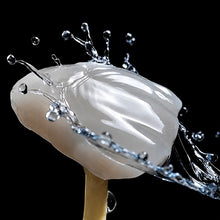 UT Multilayer zirconia crown with natural cervical-to-incisal gradient translucency, shown in a close-up studio shot with water splash effect